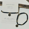 Black beaded zodiac charm bracelet with gold accents, capricorn zodiac charm