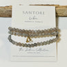 Beaded bracelet with a libra charm on a Santore branded card.